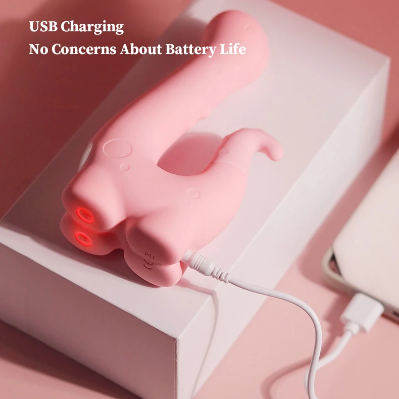 Close-up of HH Little Dino charging via a universal USB cable on a sleek bedside setup.