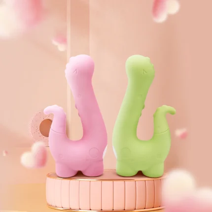 HH Little Dino adult toys displayed in Medium Pink and Grass Green colors on a decorative podium.