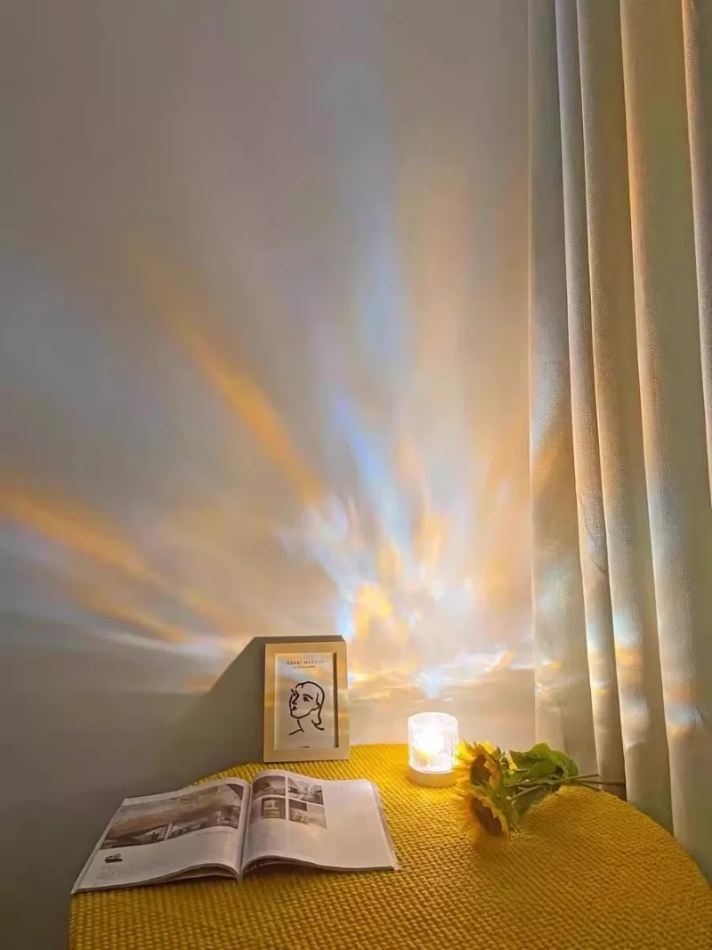 Modern home decor with a small aurora mood lamp projecting rainbow light near sunflowers.