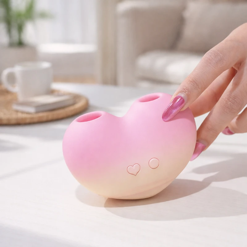 HooHss peach heart pink silicone vibrator on desk