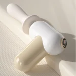 Close-up of the detachable head and LCD interface of the mini massage tool.