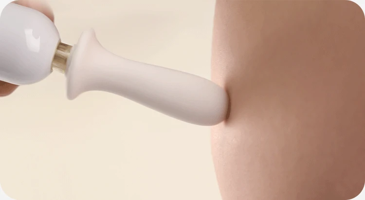 Soft silicone head of the personal wand massager applying pressure to skin.