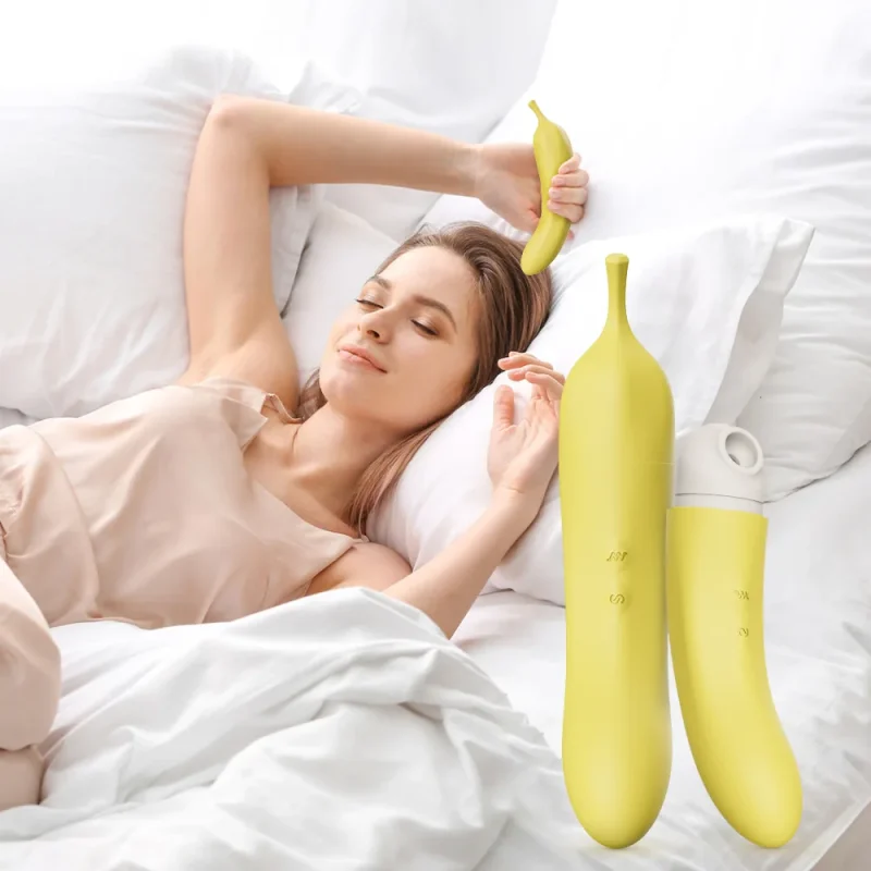 Lifestyle shot of a woman relaxing in bed with the discreet banana-themed clitoral stimulator, showcasing its portable and travel-friendly size.