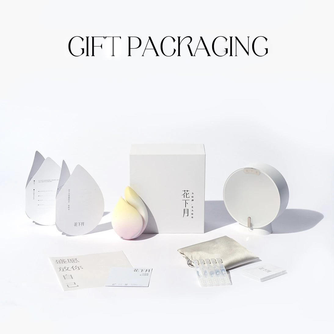 Complete unboxing experience of the Budding Moon pleasure set, featuring the petal-shaped vibrator, discreet storage pouch, charging base, and premium gift packaging components.