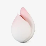 Close-up shot of the Budding Moon clitoral stimulator, highlighting the soft-touch medical-grade silicone and the delicate pink-to-white gradient petal design.