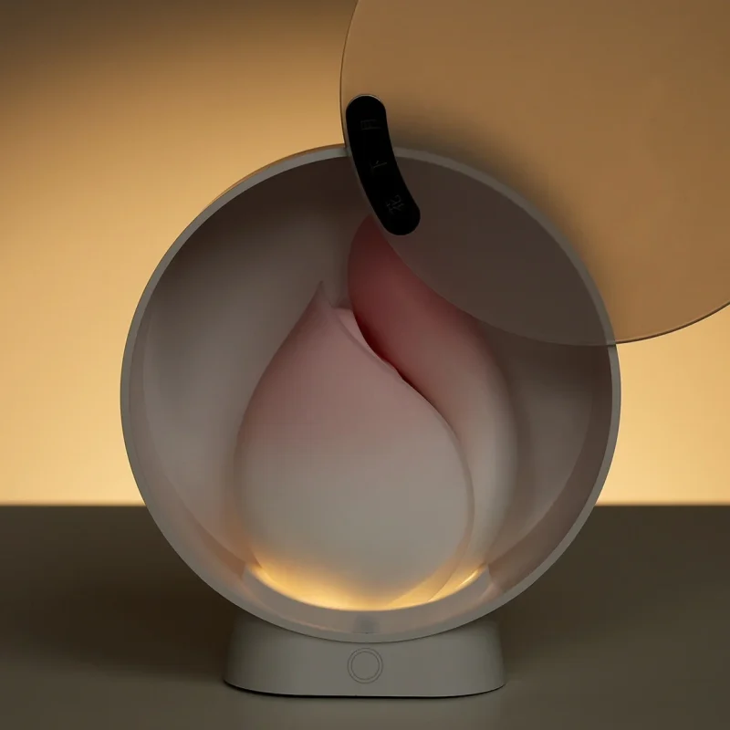 The HH Budding Moon stored in its elegant, vanity-mirror inspired charging case which features a soft-glow built-in night light.