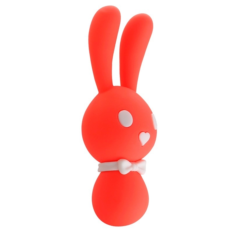 Side profile of the coral-colored Lovely Bunny pleasure tool, showcasing the ergonomic curves and smooth silicone finish of this dual-stimulation device.