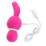 Pink Dorcel Lovely Bunny shown with its included white USB charging cable, emphasizing the travel-friendly and rechargeable nature of this wellness product.