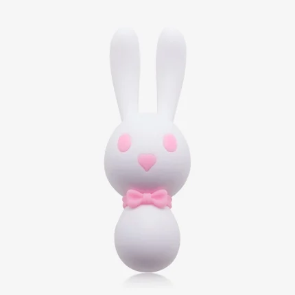 Front view of the white Dorcel bunny vibrator highlighting its adorable aesthetic, featuring pink heart-shaped eyes and a charming bow tie detail at the neck.