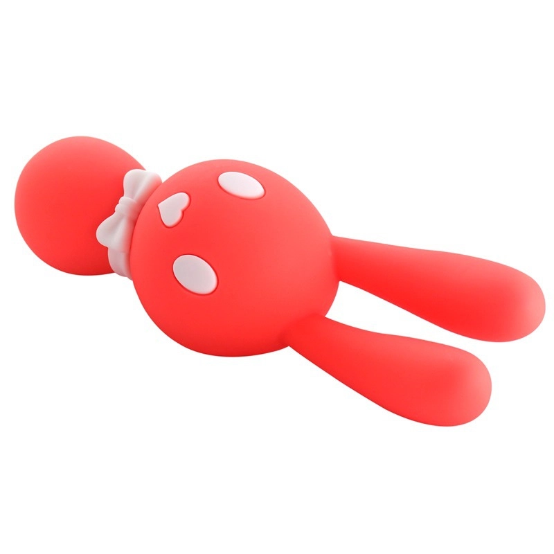 Perspective view of the red bunny clitoral massager lying flat, highlighting the flexible ears and the smooth, non-porous finish for easy cleaning.