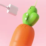 Close-up detail of the magnetic USB charging port located on the green leafy top of the adult toy, highlighting the convenient and hygienic cordless power system.