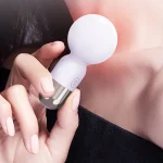 Close-up of the HH Candy Massager Mini being used as a targeted clitoral stimulator, highlighting the soft-touch body and high-shine metallic base.