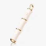 High-angle studio shot of a bamboo-shaped pleasure tool with gold bands and a crystal-inlaid loop.