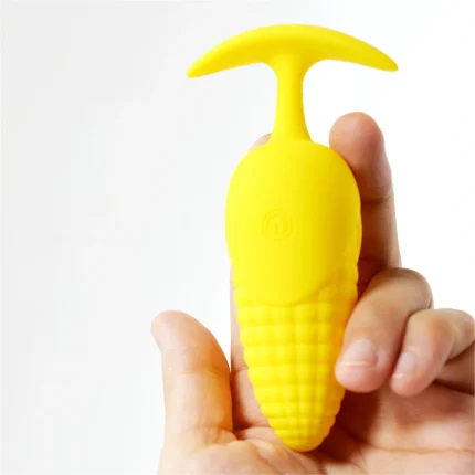 Handheld shot illustrating the compact, ergonomic size and smooth finish of the silicone corn-themed massage tool.