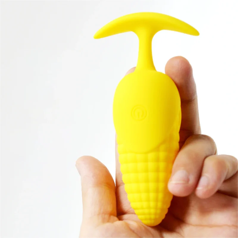 Handheld shot illustrating the compact, ergonomic size and smooth finish of the silicone corn-themed massage tool.