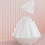 Elegant pleasure device featuring a removable magnetic cap and faceted crystal-inspired design for discreet storage.