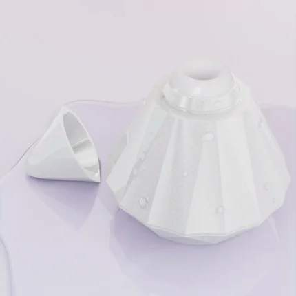 Top-down view of the ergonomic suction head and cap on a sleek, moisture-resistant pearlescent surface.