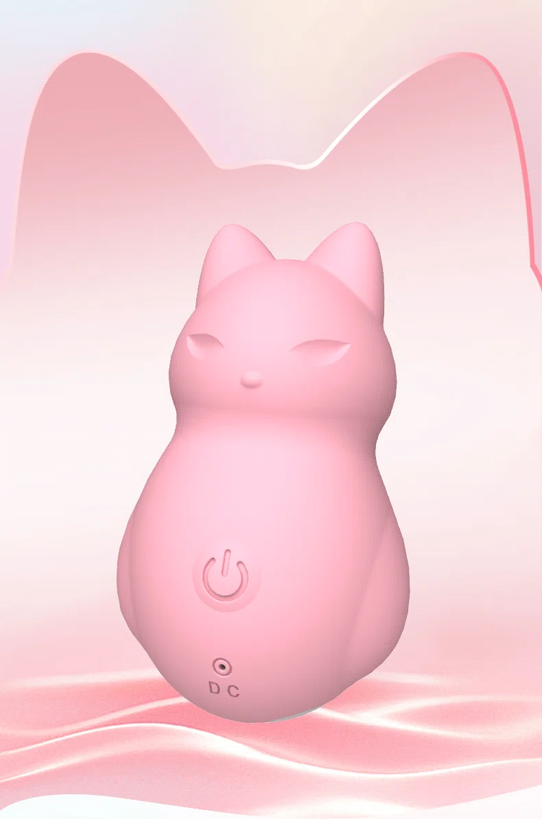 Front view of the Cunning Little Fox clitoral stimulator in pastel pink, highlighting the ergonomic cat-inspired design and central power button.