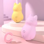 Discreet yellow and pink pocket-sized massagers styled in a modern bedroom setting to highlight their portable and decorative appearance.