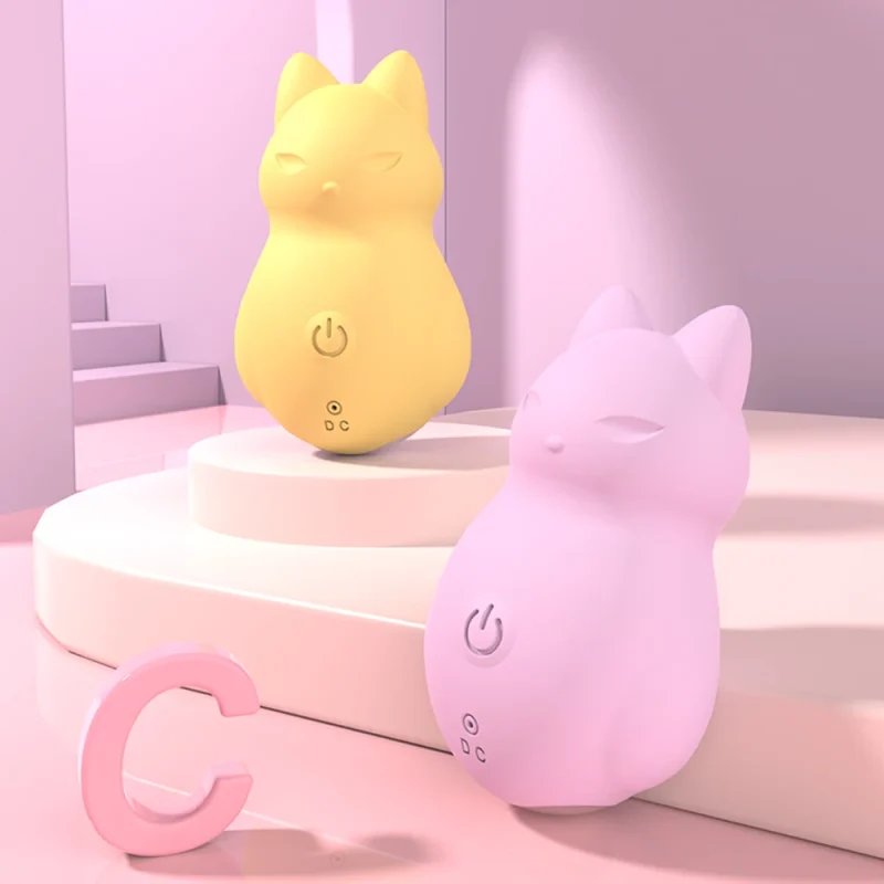 Discreet yellow and pink pocket-sized massagers styled in a modern bedroom setting to highlight their portable and decorative appearance.