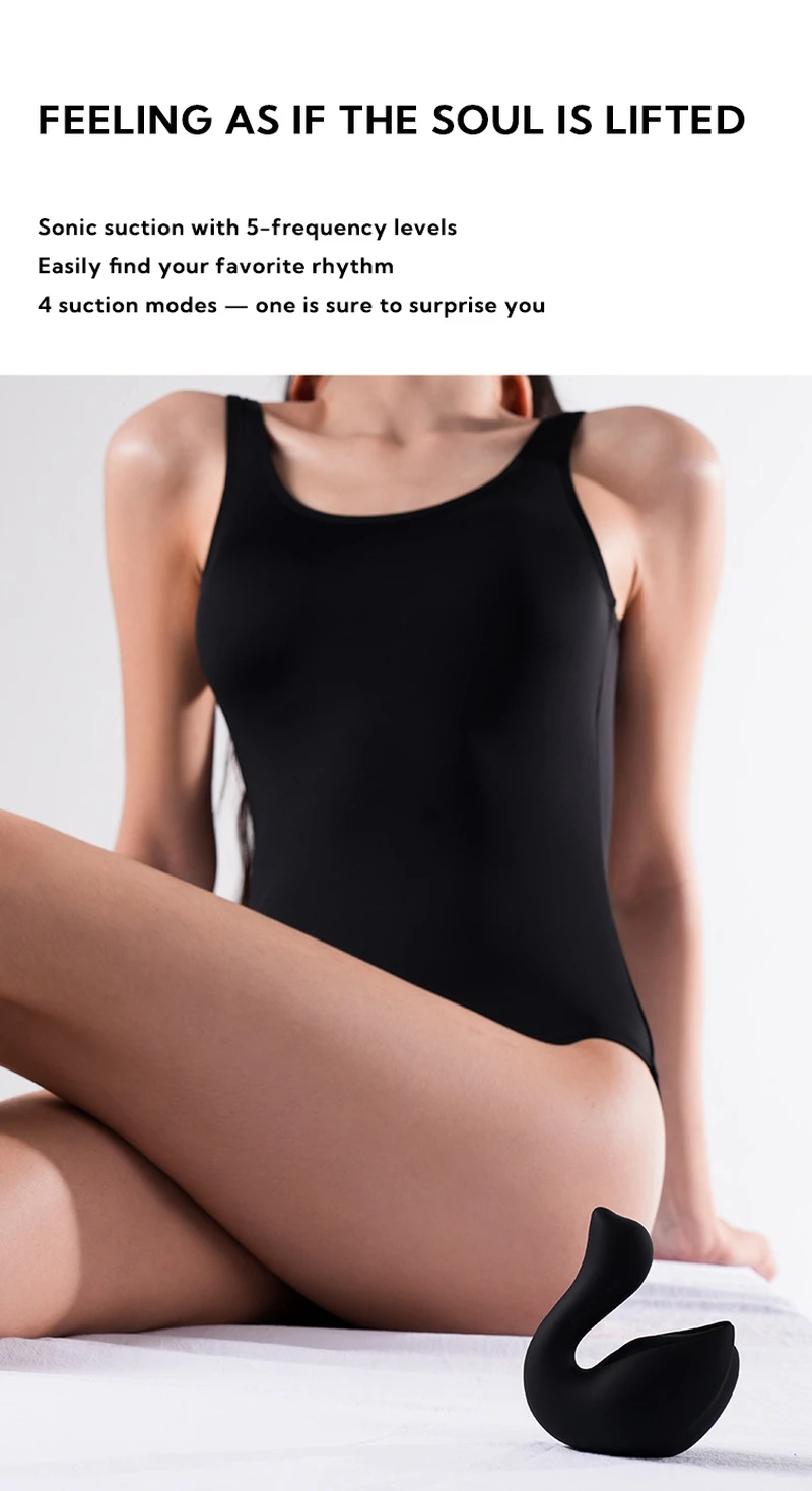 A black Cygnus sonic suction device placed in a modern bedroom setting, emphasizing its sophisticated and travel-friendly appeal.