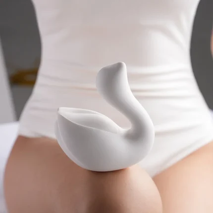 Side profile of the white Cygnus pleasure device showcasing the seamless, ergonomic body designed for external massage.
