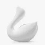 Side profile of the white Cygnus pleasure device showcasing the seamless, ergonomic body designed for external massage.