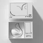 Luxury gift box packaging featuring the swan-shaped pleasure device and a discreet instruction manual.