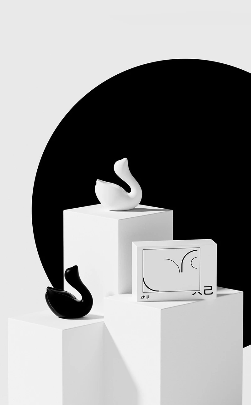 Elegant product lineup showing the Cygnus swan vibrator in both black and white colorways with branded packaging.