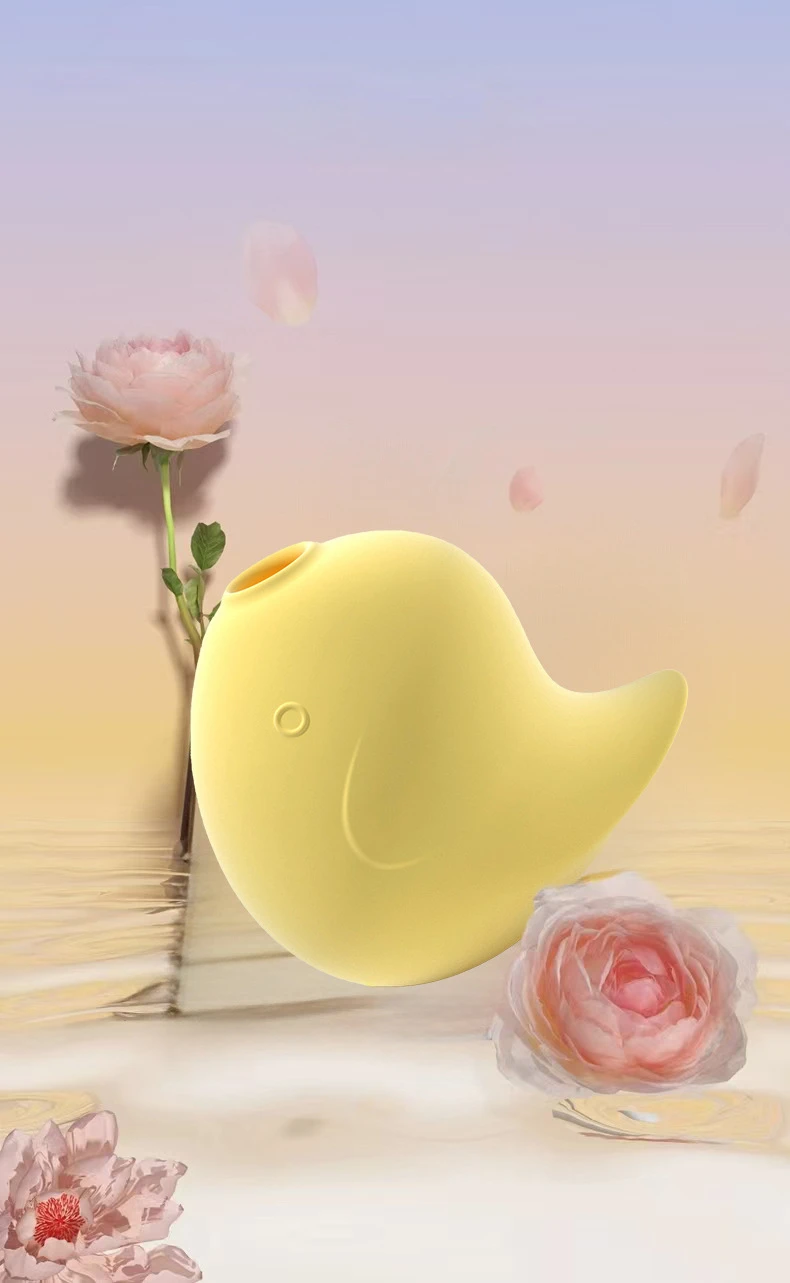 Artistic product photography of the yellow Dudu Bird wellness device floating among blooming roses, symbolizing the soft touch and romantic essence of this premium toy.