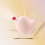 A pink Dudu Bird pulse vibrator interacting with a water droplet, visually representing the powerful sonic suction and air-pulse technology used for targeted stimulation.