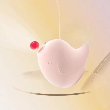 A pink Dudu Bird pulse vibrator interacting with a water droplet, visually representing the powerful sonic suction and air-pulse technology used for targeted stimulation.