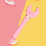 Aesthetic product shot of a pink handheld vibrator for women set against a modern pastel background with soft feathers representing gentle stimulation.
