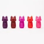Rear view of five different colored intimacy candles showcasing the detailed tail design of the fox mold.
