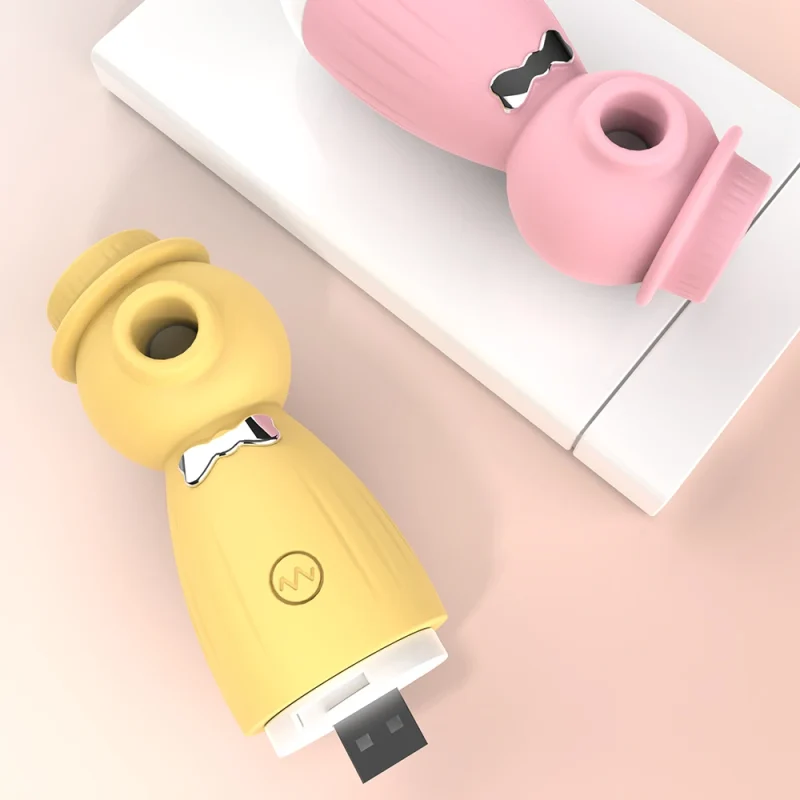 Top-down view of pink and yellow travel-friendly vibrators showing the integrated USB plug for cable-free charging.