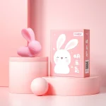 Product packaging view featuring the pink bunny vibrator alongside its stylish, gift-ready box with "Happy Bunny" branding in a feminine aesthetic.