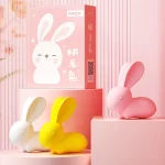 A collection of white, yellow, and pink rabbit massagers arranged with their professional packaging to show the full color lineup.