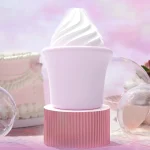 Product hero shot of the soft-serve ice cream-style vibrator on a pink pedestal, showcasing the premium matte finish and sophisticated pastel aesthetic.