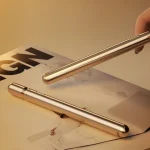 Close-up of the Joy Rod's sleek metallic finish and minimalist power button, highlighting its discreet pen-style appearance.