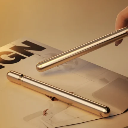 Close-up of the Joy Rod's sleek metallic finish and minimalist power button, highlighting its discreet pen-style appearance.