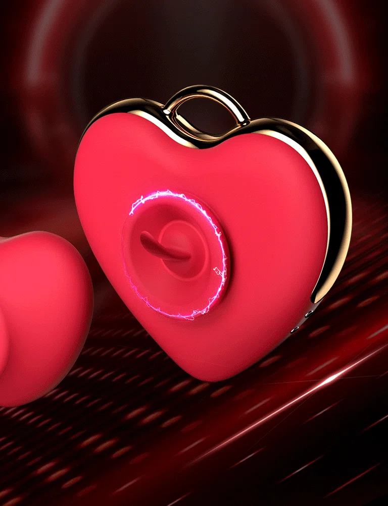 Close-up of the clitoral stimulation node on the heart-shaped pleasure device, highlighting the internal licking tongue mechanism.