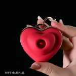 Close-up of a hand holding a compact heart-shaped tongue stimulator, highlighting the soft-touch medical-grade silicone texture and ergonomic design for precision pleasure.
