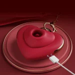 Rechargeable adult wellness device featuring a magnetic USB charging port and a sleek heart silhouette with gold-rimmed detailing for a luxury aesthetic.
