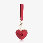 Full view of a portable red heart-shaped clitoral massager with a matching lanyard and quick-release clasp, ideal for travel-friendly and discreet storage.