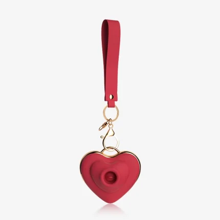 Full view of a portable red heart-shaped clitoral massager with a matching lanyard and quick-release clasp, ideal for travel-friendly and discreet storage.