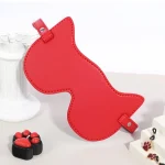 Detailed shot of the red cat-ear shaped blindfold made from soft, high-quality faux leather with an adjustable buckle strap for a comfortable, light-blocking fit.