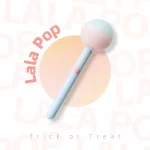 Artistic product shot of the Lala Pop pastel-colored clitoral stimulator against a soft peach and white background, highlighting its lollipop-inspired aesthetic.