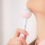 Close-up of the Lala Pop massage wand being used for gentle neck and jawline stimulation, showcasing its ergonomic round silicone head.