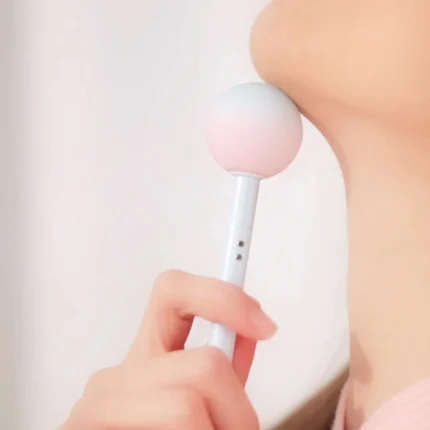 Close-up of the Lala Pop massage wand being used for gentle neck and jawline stimulation, showcasing its ergonomic round silicone head.