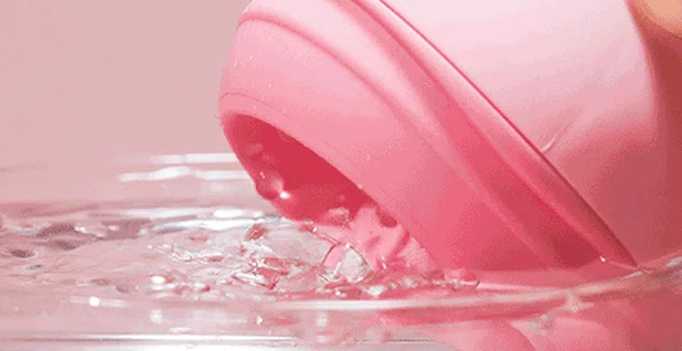 Waterproof adult toy being rinsed under water to showcase its easy-to-clean design and IPX7 submersible rating.